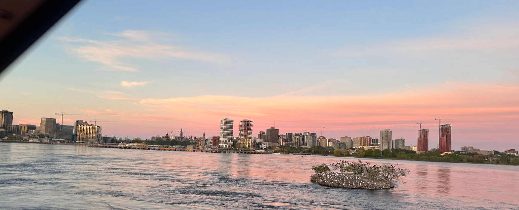 An evening shot of Downtown Ottawa from the William Commanda Bridge.